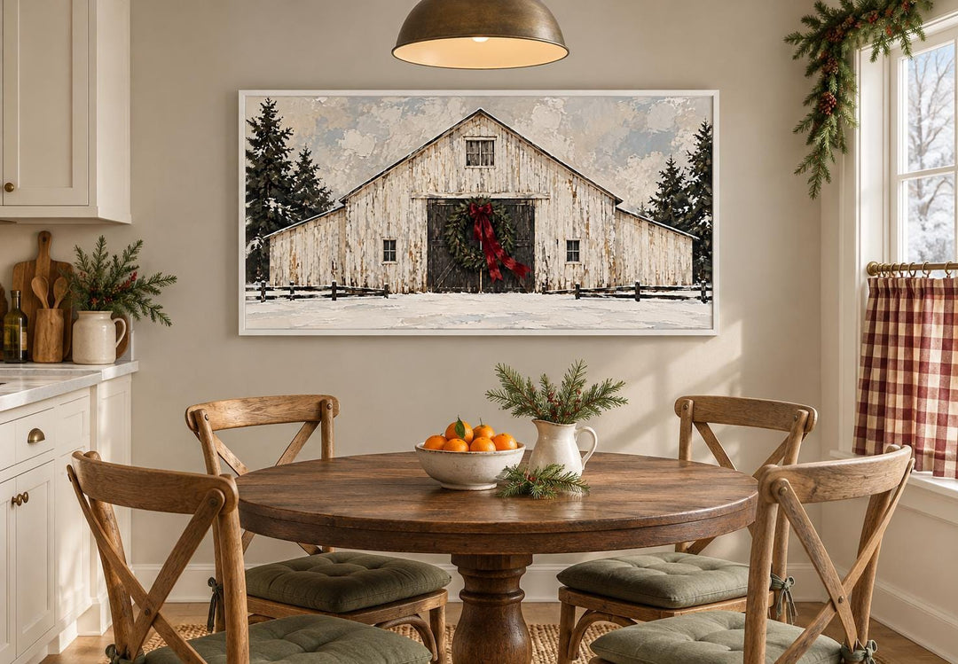 White Christmas barn framed canvas wall art with evergreen wreath and burgundy bow over dining table