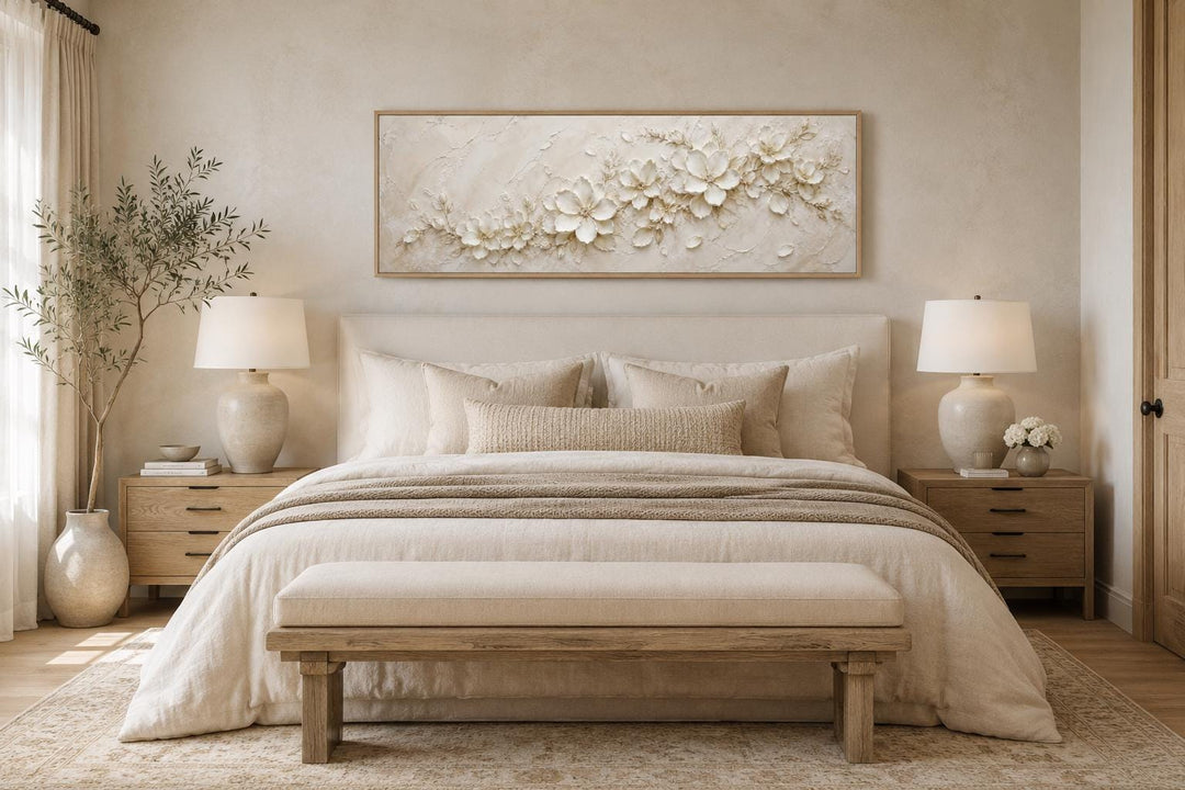 Long horizontal white floral canvas art with textured 3D-effect petals above a neutral bed.