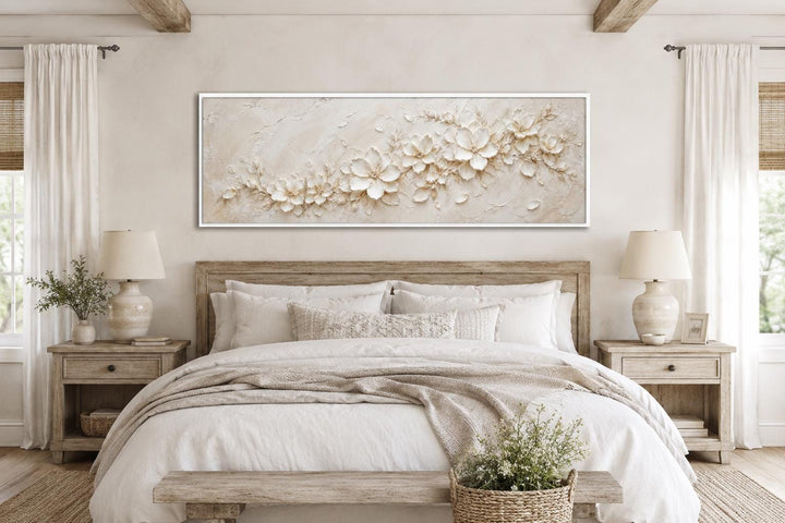 Long horizontal canvas with textured white and cream floral art above a neutral-toned bed.