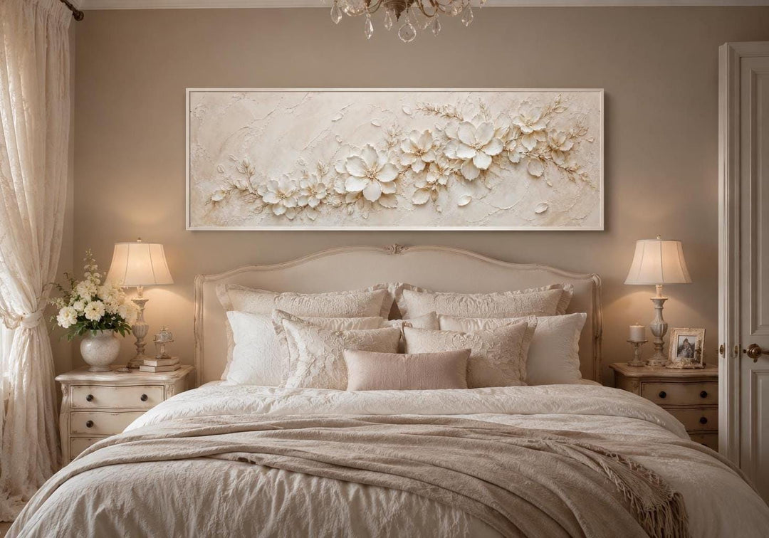 Long horizontal white floral canvas art with textured 3D-effect petals above a neutral bed.