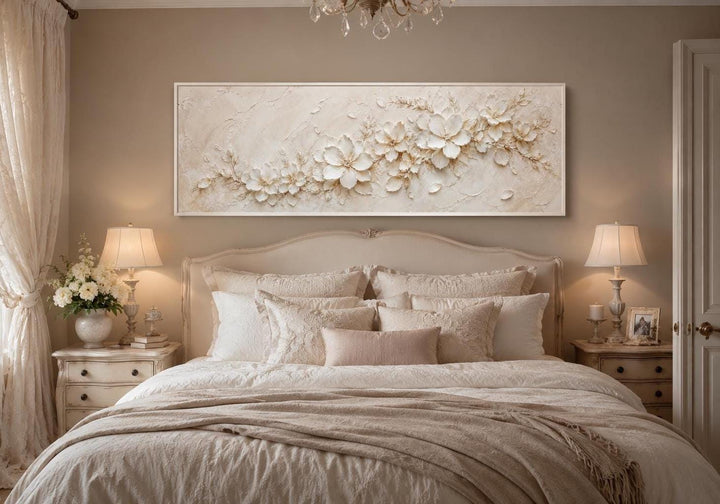 Long horizontal white floral canvas art with textured 3D-effect petals above a neutral bed.