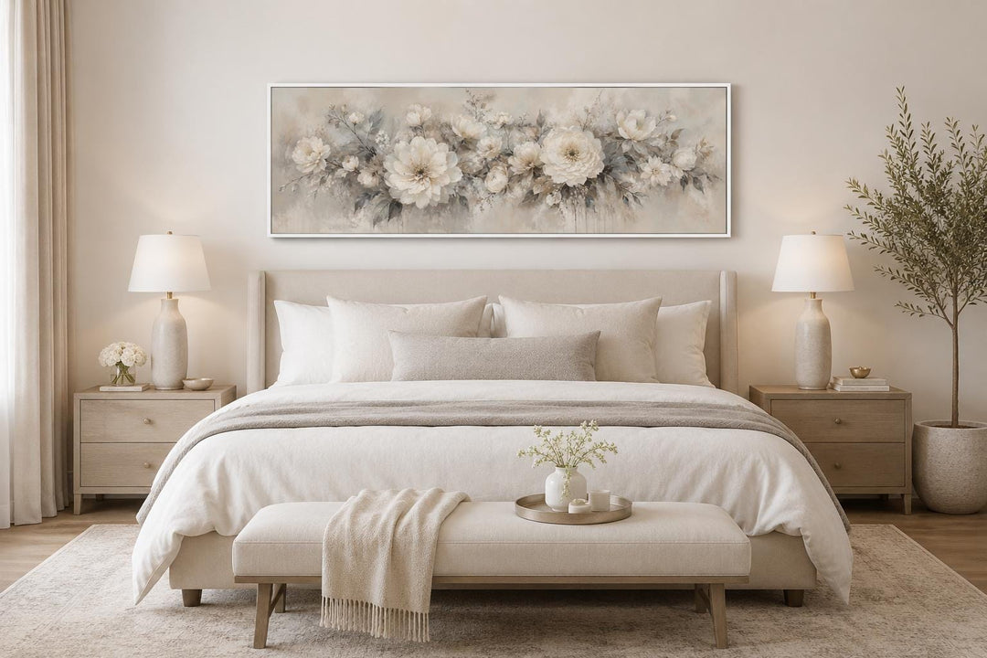 Long horizontal canvas print of white peonies in a soft, painterly style hanging above a bed.