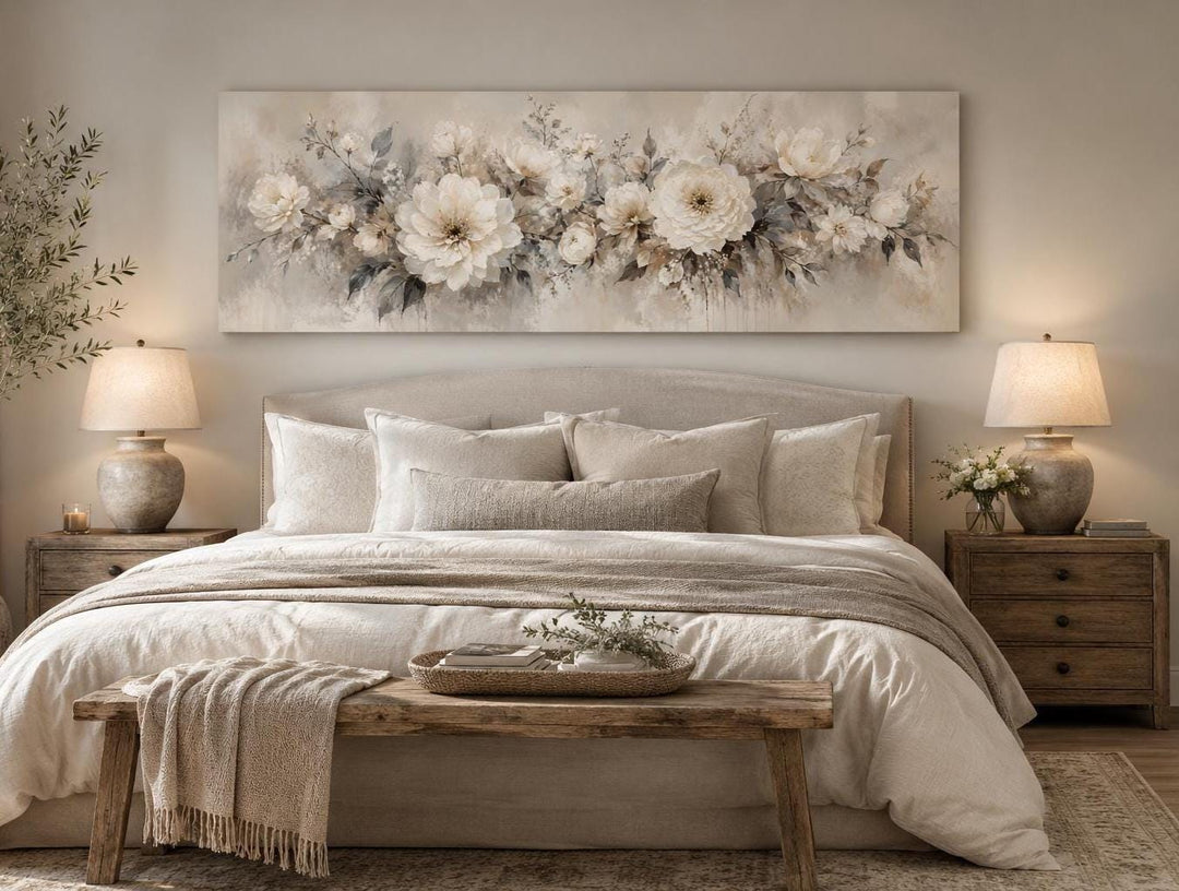 Long horizontal canvas print of white peonies in a romantic painting style above a bed.