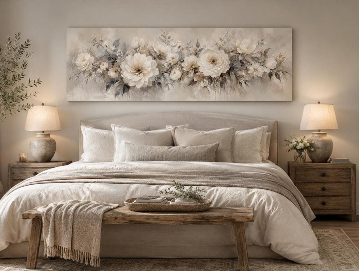 Long horizontal canvas print of white peonies in a romantic painting style above a bed.