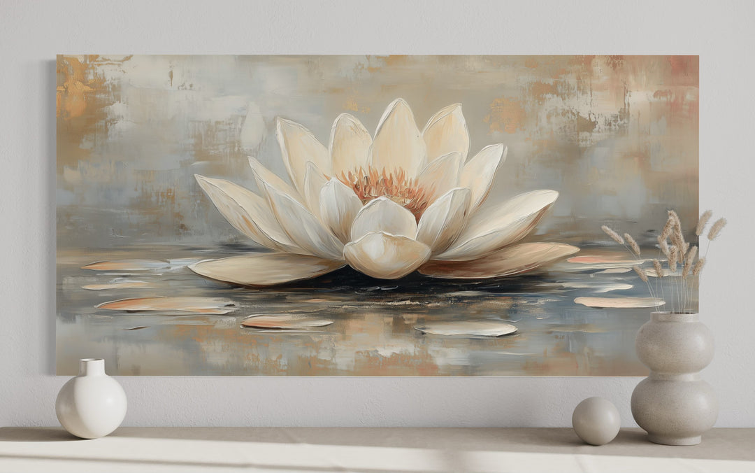 White and gold abstract lotus flower painting on canvas displayed above a neutral console table.