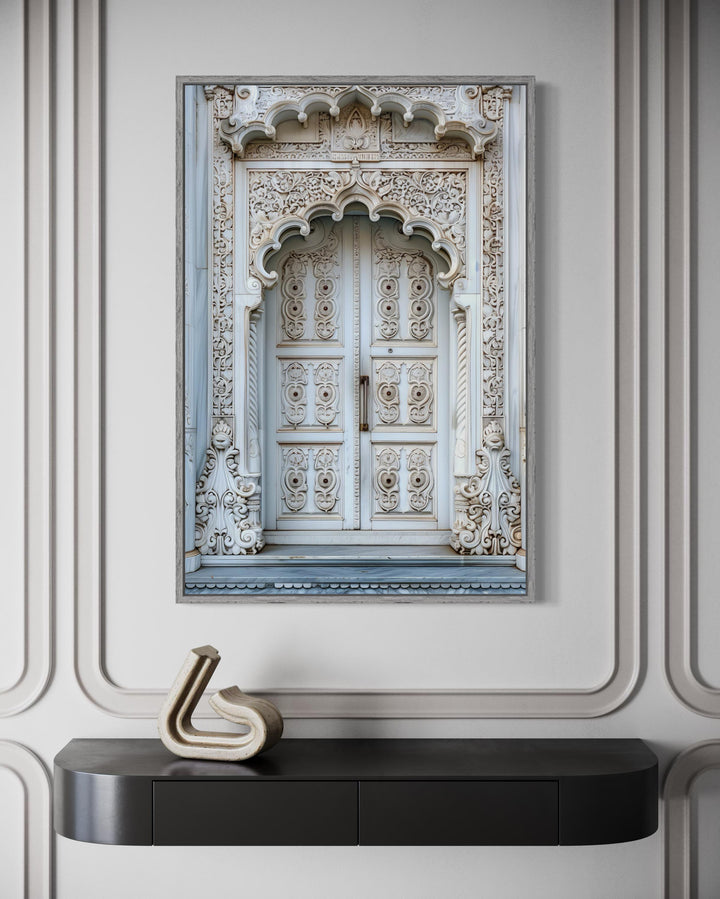 White and grey framed canvas wall art of an intricately carved traditional Indian door.
