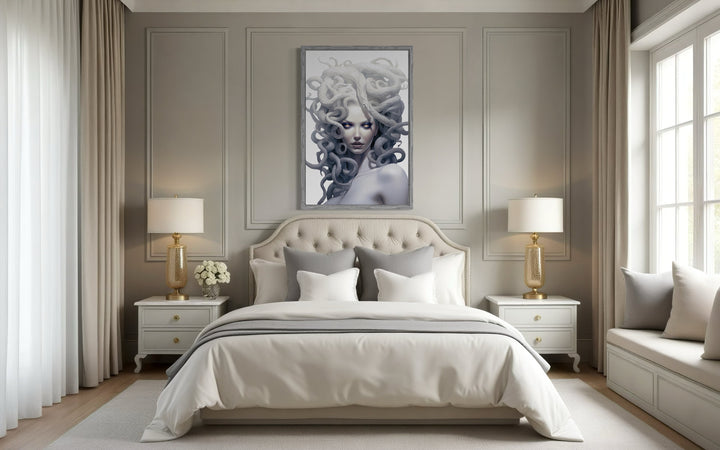 White Medusa Greek Gorgon framed canvas wall art hanging above a bed in a neutral-toned bedroom.