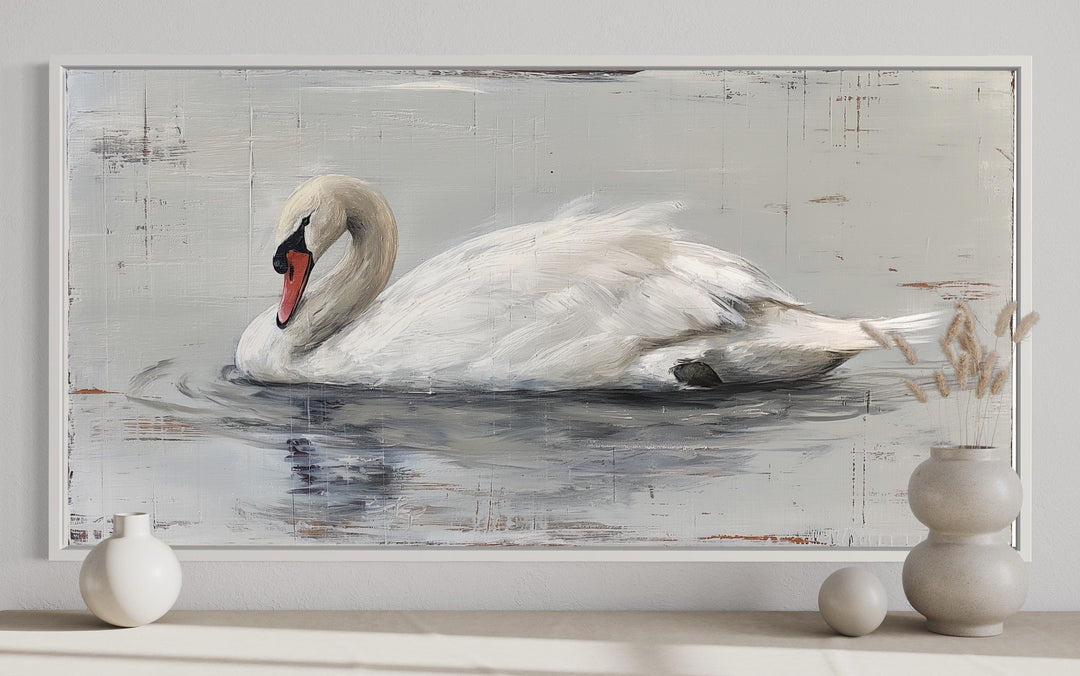 Rustic canvas painting of a white swan on water in a white frame, styled with farmhouse decor.