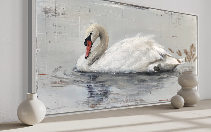 Rustic canvas painting of a white swan on water, framed and displayed in a farmhouse-style room.