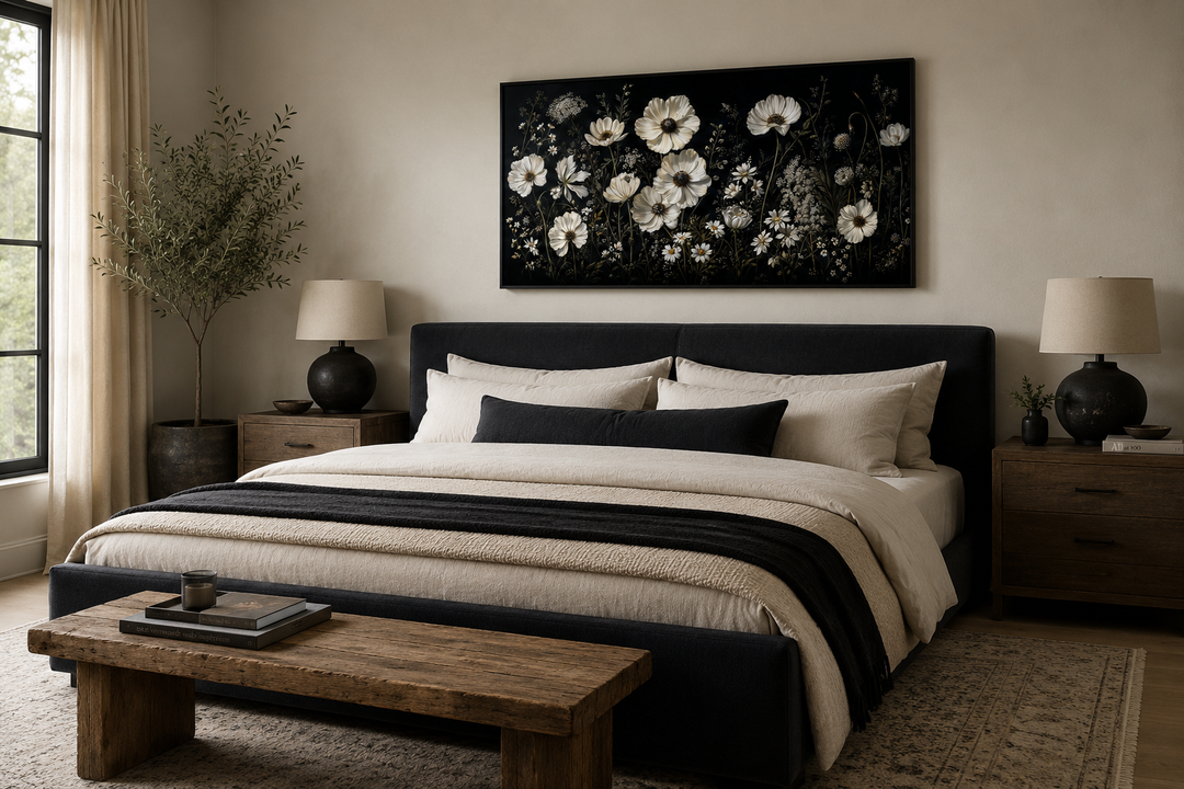 White wildflowers on black background moody framed canvas wall art hanging above a bed.