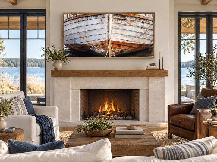 Rustic white and brown old wooden boat canvas art framed above a fireplace in a coastal living room.