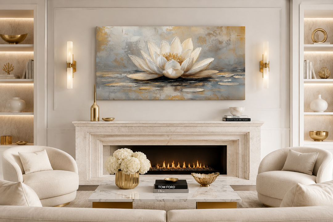 White and gold neutral lotus flower framed canvas wall art hanging above a marble fireplace.