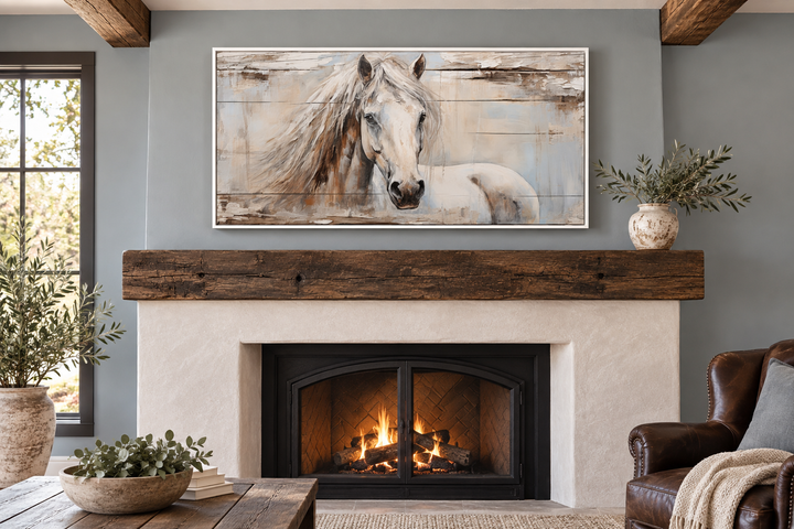 Rustic white horse painting on distressed wood canvas above a cozy fireplace in a farmhouse room.