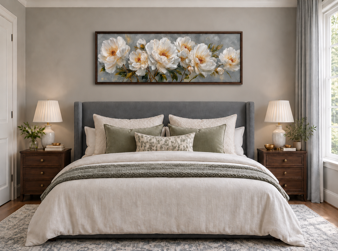 White cream peonies long horizontal framed canvas wall art hanging above a bed in a neutral bedroom.
