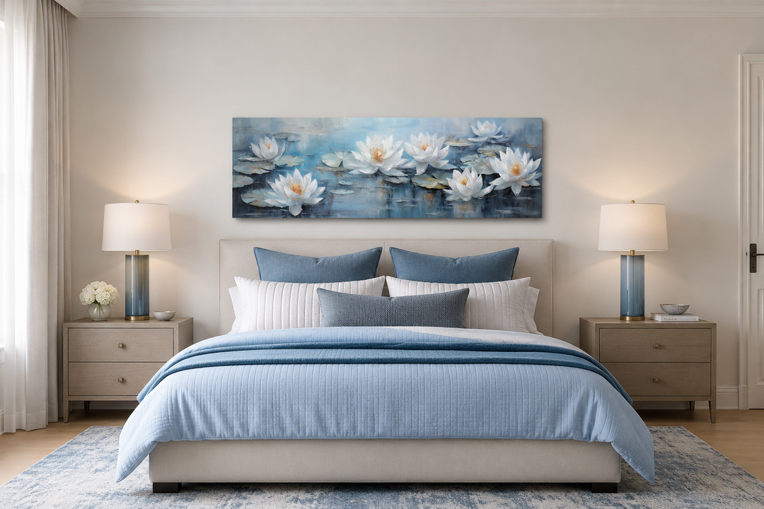White lotus flowers horizontal narrow canvas wall art above a bed in a blue and white bedroom.