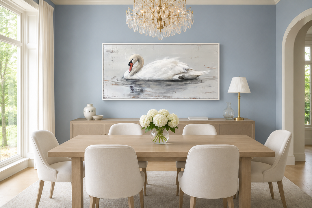 Framed white swan canvas painting on a blue wall in a modern farmhouse dining room.