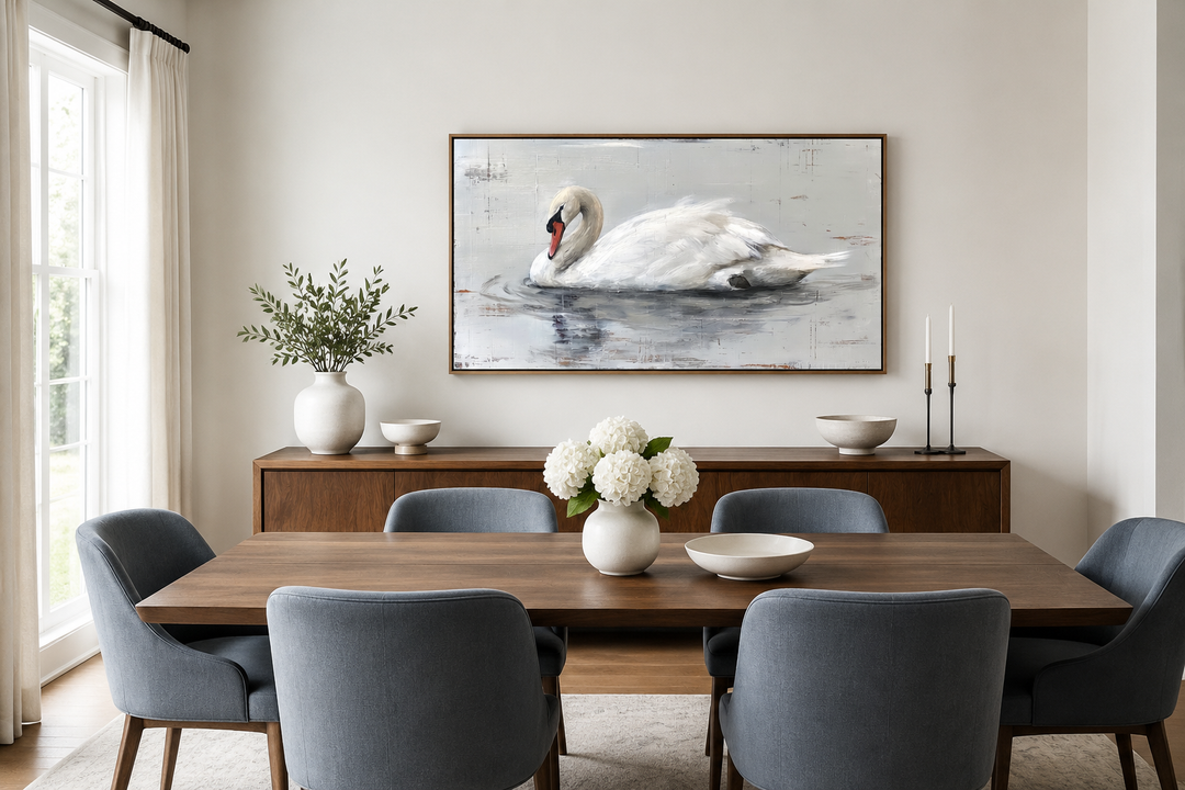 Framed white swan canvas painting on a wall above a wooden sideboard in a modern dining room.