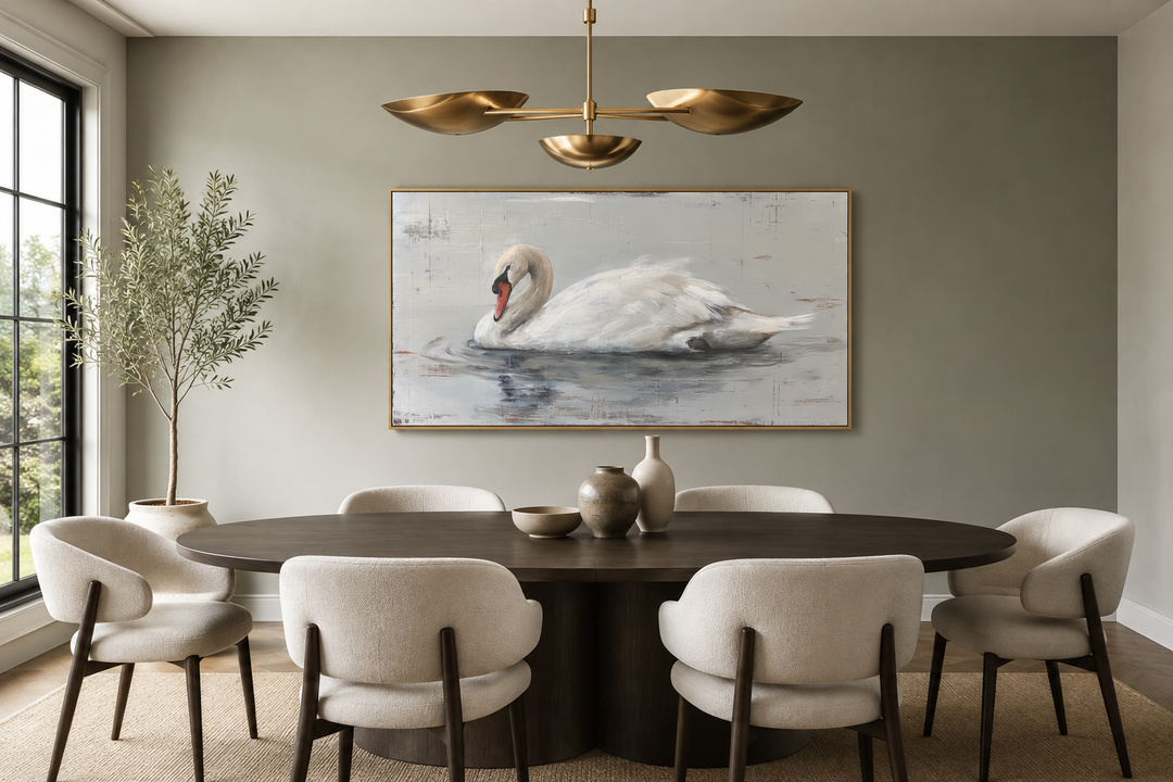 Framed white swan canvas painting on a neutral wall above a modern dining table and chairs.
