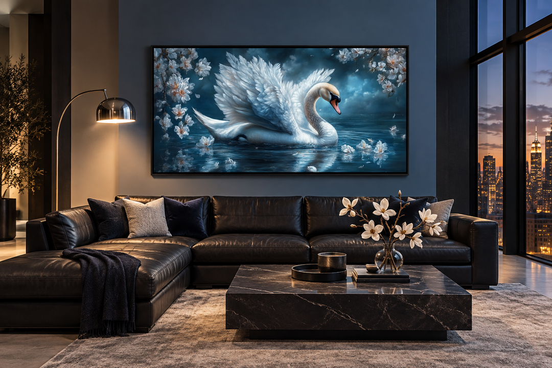 White swan canvas wall art on a blue wall above a black leather sofa in a modern living room.