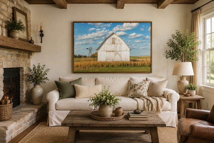 Old weathered white barn with windmill framed canvas wall art in a farmhouse living room.