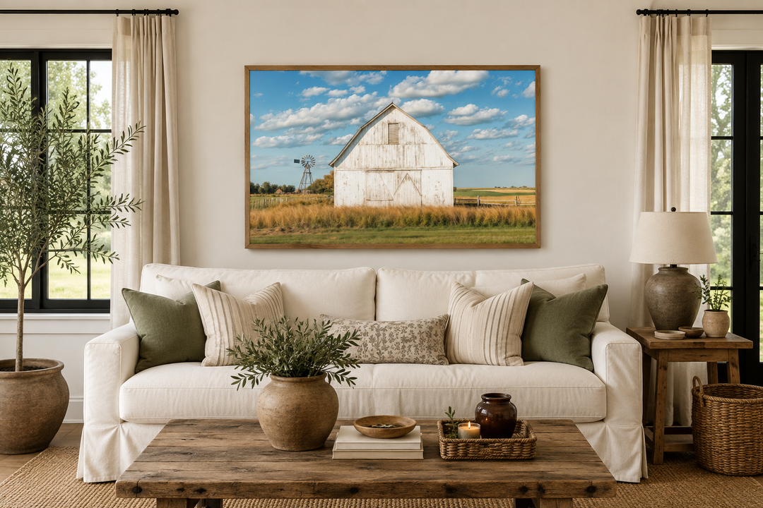 Old weathered white barn with windmill framed canvas wall art in a farmhouse living room.