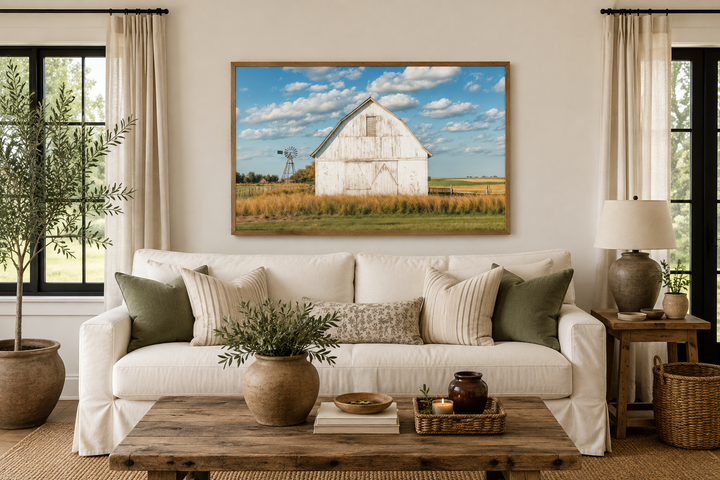 Old weathered white barn with windmill framed canvas wall art in a farmhouse living room.