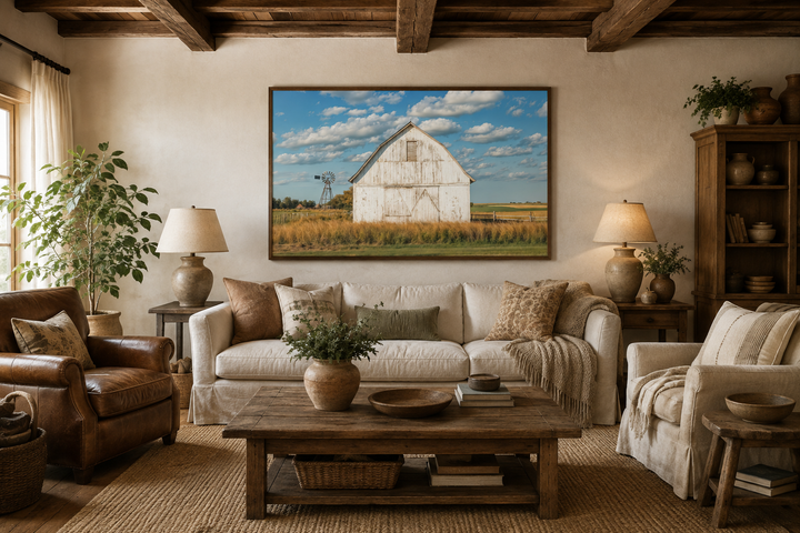 Old weathered white barn with windmill framed canvas wall art in a rustic farmhouse living room.