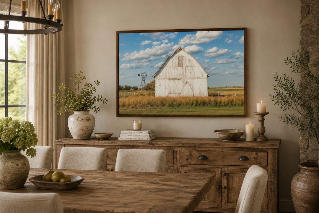 Framed canvas wall art of a weathered white barn and windmill in a field under a blue sky.