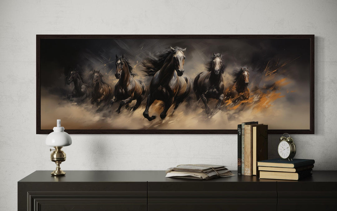 Wild brown galloping horses long horizontal canvas wall art above a dark wood dresser.