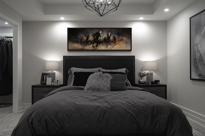 Wild brown galloping horses long horizontal canvas wall art hanging above a dark modern bed.