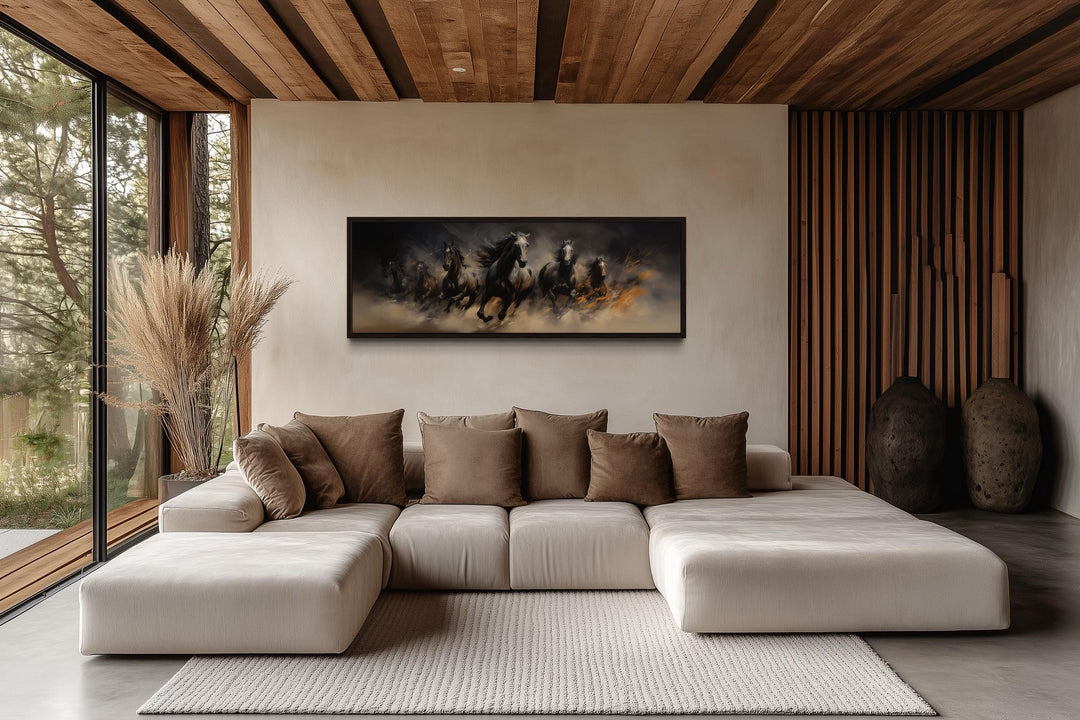 Wild brown galloping horses long horizontal canvas wall art above a modern sectional sofa.
