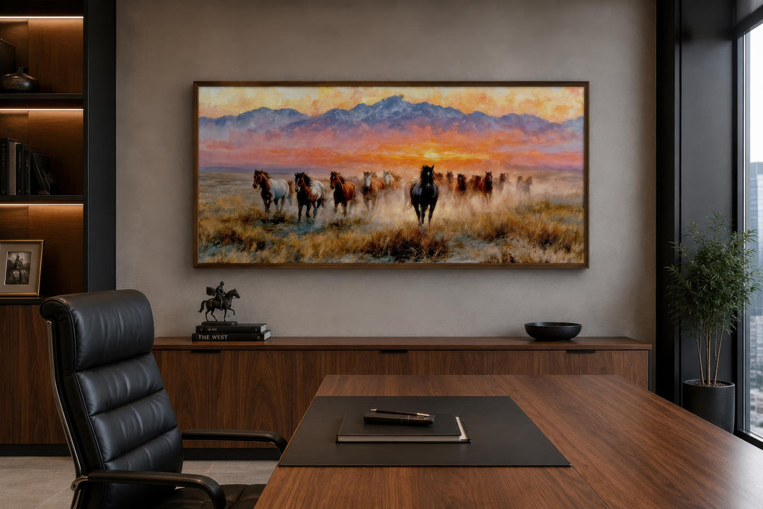 Wild Mustang wall art featuring a herd of horses running at sunset in a modern office setting.