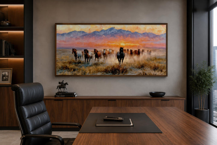 Wild Mustang wall art featuring a herd of horses running at sunset in a modern office setting.