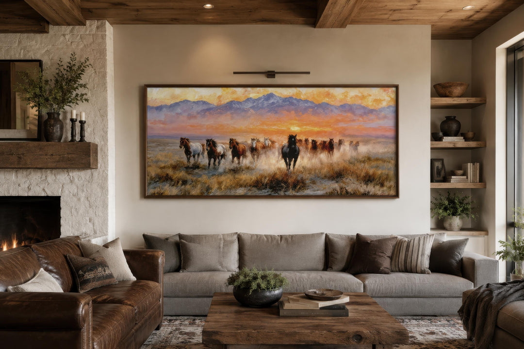 Wild Mustang wall art featuring a herd of horses running at sunset over a living room sofa.