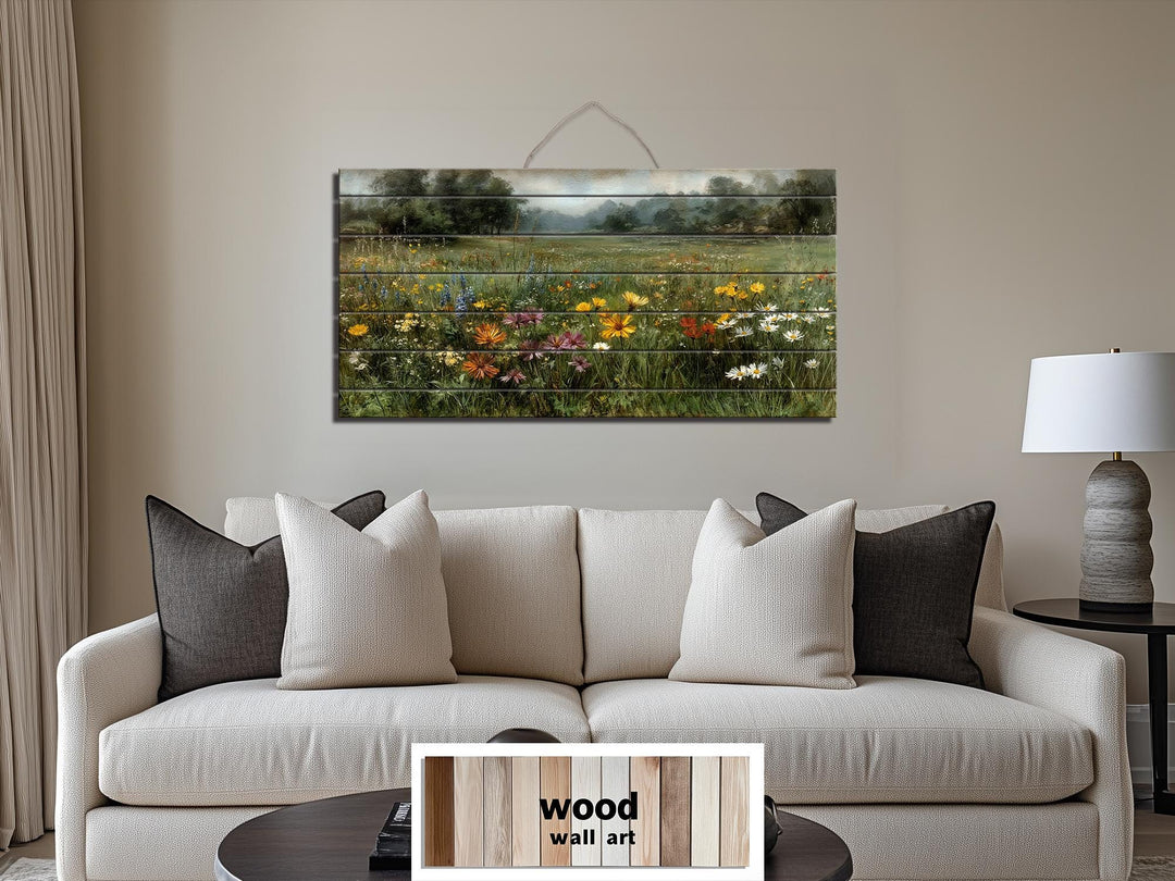 Wildflower field landscape printed on rustic wood planks hanging above a neutral sofa.