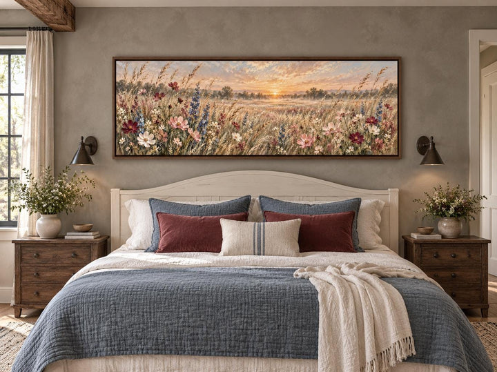 Wildflower Meadow Sunrise long narrow canvas wall art hanging above a bed in a rustic bedroom.