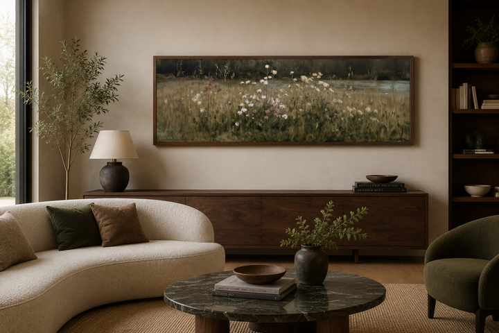 Long narrow wildflower meadow canvas art in a dark wood frame above a mid-century modern sideboard.