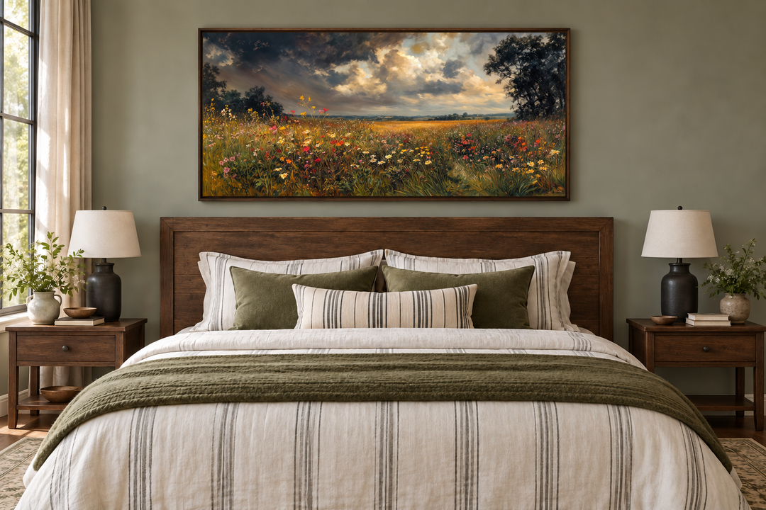 Antique style moody wildflowers field framed canvas wall art hanging above a bed in a bedroom.