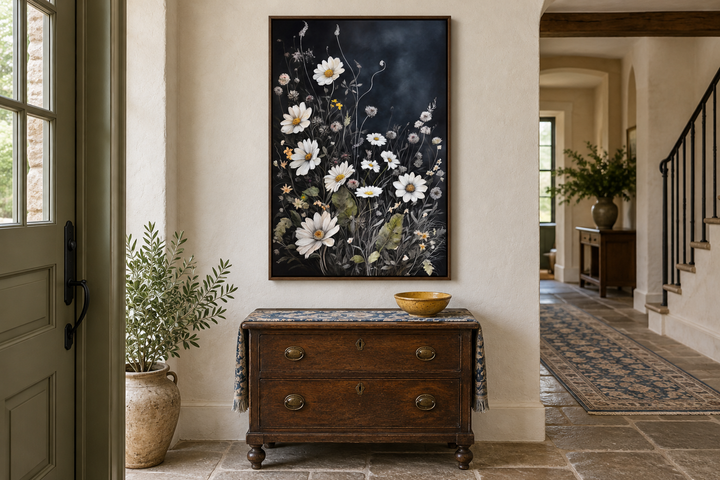 Black and white chamomile wildflowers framed canvas wall art in a rustic entryway.