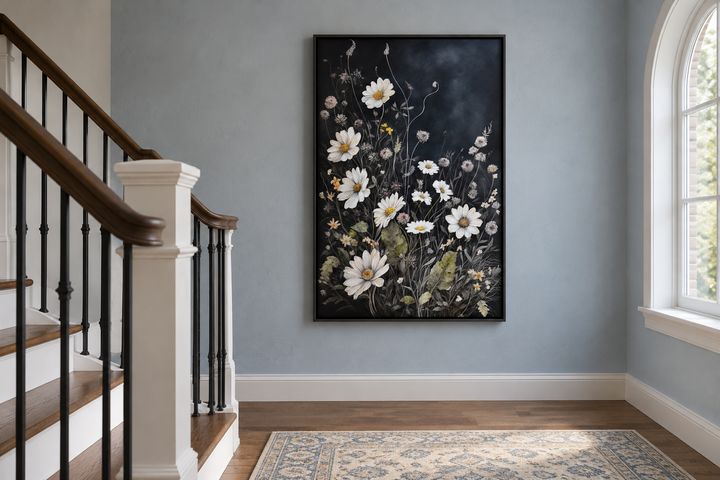 Black and white wildflowers chamomile framed canvas wall art hanging on a blue wall by a staircase.