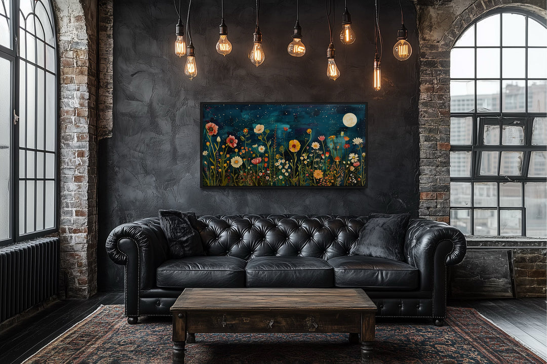 Wildflowers field at night under moon large horizontal wall art above a black leather sofa.