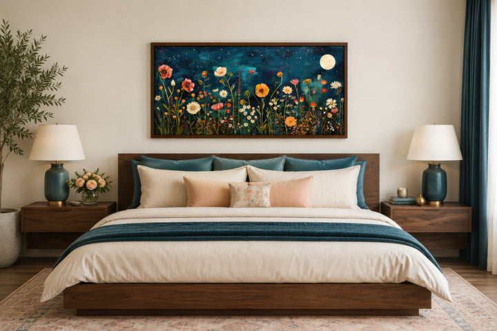 Large horizontal wall art of a wildflower field at night under a full moon above a bed.