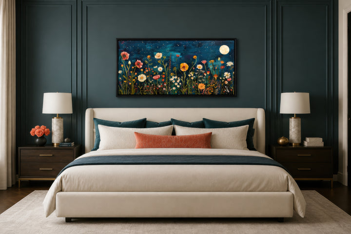 Large horizontal wall art of a wildflower field at night under a moon, hanging above a bed.