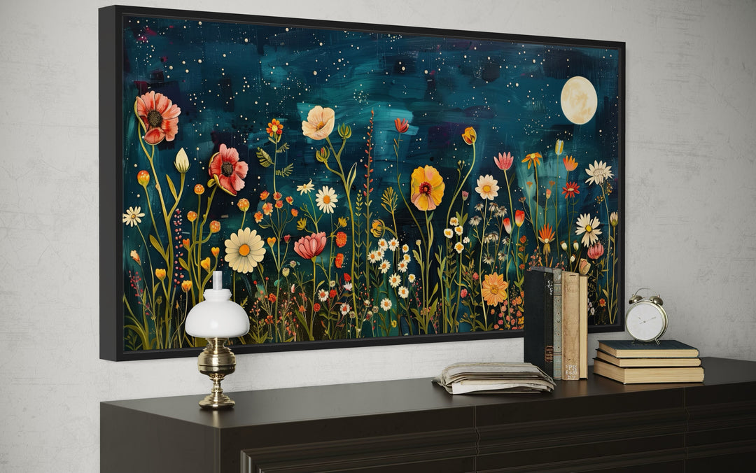 Large horizontal wall art of a wildflower field at night under a full moon on a dark blue sky.