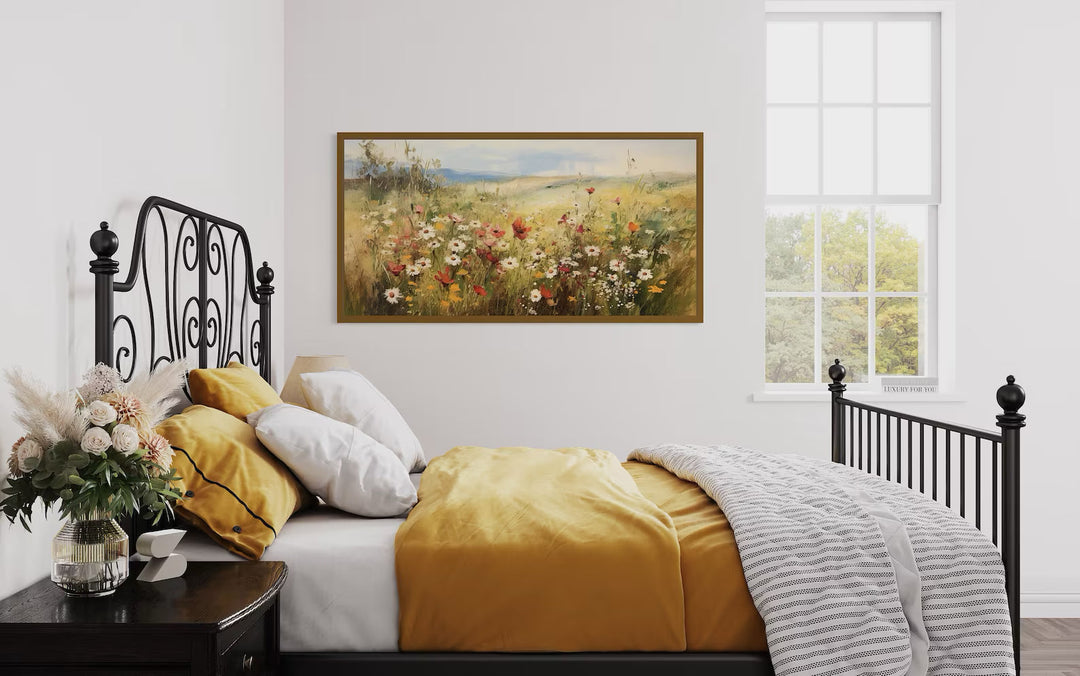 Panoramic farmhouse canvas wall art featuring a field of wildflowers above a bed with yellow linens.
