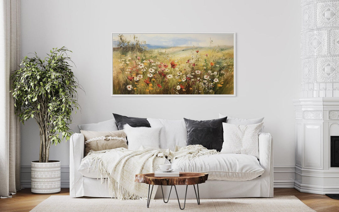 Panoramic farmhouse canvas wall art featuring a vibrant field of wildflowers above a white sofa.