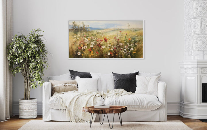 Panoramic farmhouse canvas wall art featuring a vibrant field of wildflowers above a white sofa.