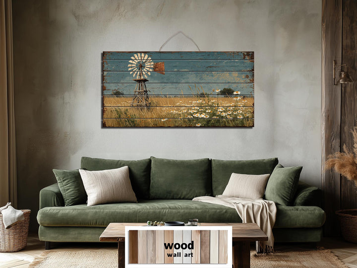 A horizontal wood wall art piece featuring a distressed windmill and wildflower field landscape.