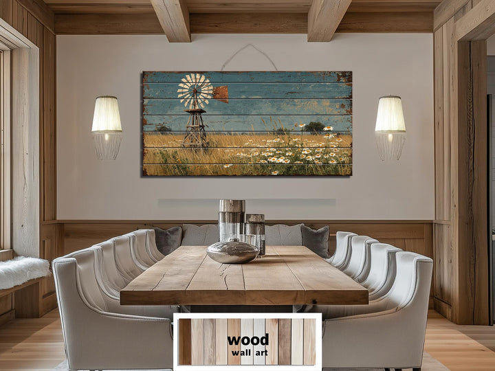 A horizontal wood wall art piece featuring a windmill and wildflowers in a rustic dining room.
