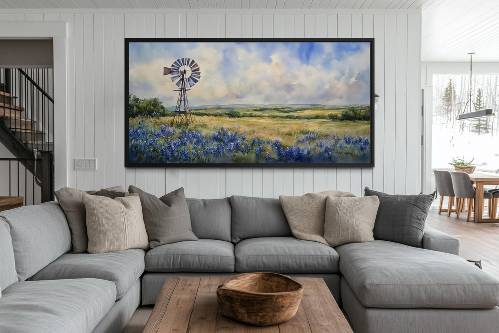 Panoramic canvas wall art of a windmill over a field of bluebonnets in a rustic living room.
